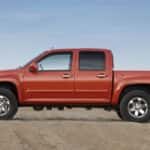 A side view of a red 2009 Chevy Colorado Z71.