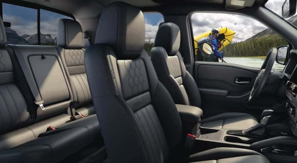 Two rows of seating in the cabin of the 2022 Nissan Frontier.