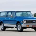 A blue 1972 Chevy Suburban is shown from the font at an angle.
