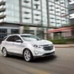 A white 2018 Chevy Equinox is shown from the front at an angle.
