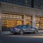 A grey 2021 Chevy Malibu is shown from the side.