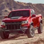 A red 2021 Chevy Colorado ZR2 is shown from the front while off-road after leaving a used truck dealer near The Woodlands.