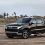 A black 2023 Chevy Silverado 1500 LT is shown from the front at an angle.