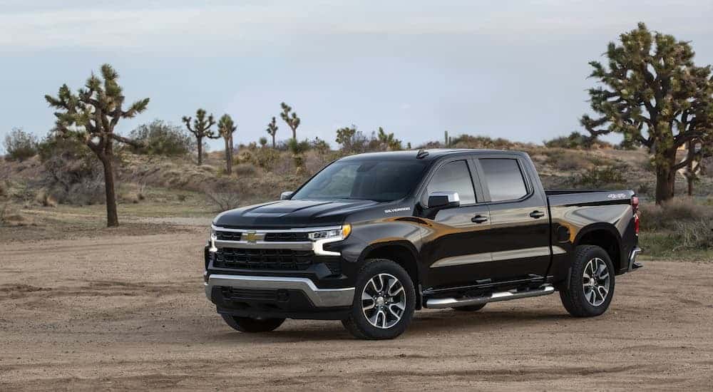 A black 2023 Chevy Silverado 1500 is shown from the front at an angle.