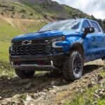 A blue 2022 Chevy Silverado 1500 ZR2 is shown from the front at an angle after leaving a dealer that has Chevy trucks for sale.