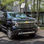 A black 2024 Chevy Silverado 2500 HD High Country is shown from the front at an angle.