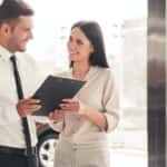 A couple is going over paperwork at a Certified pre-owned Chevy dealer.