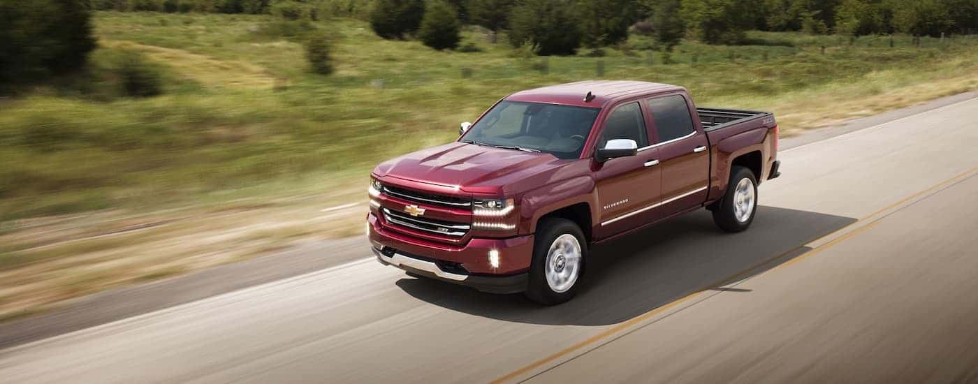 A red 2017 Chevy Silverado 1500 LTZ Z71 is shown speeding down an empty road