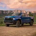 A blue 2023 Chevy Silverado 1500 ZR2 is shown on a trail after leaving a Chevy Silverado dealer near The Woodlands, TX.