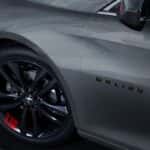 A close up shows a black rim on a silver 2023 Chevy Malibu Redline.