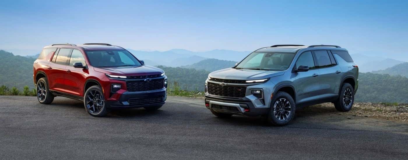 A red 2024 Chevy Traverse RS and a grey Z71 are shown facing each other