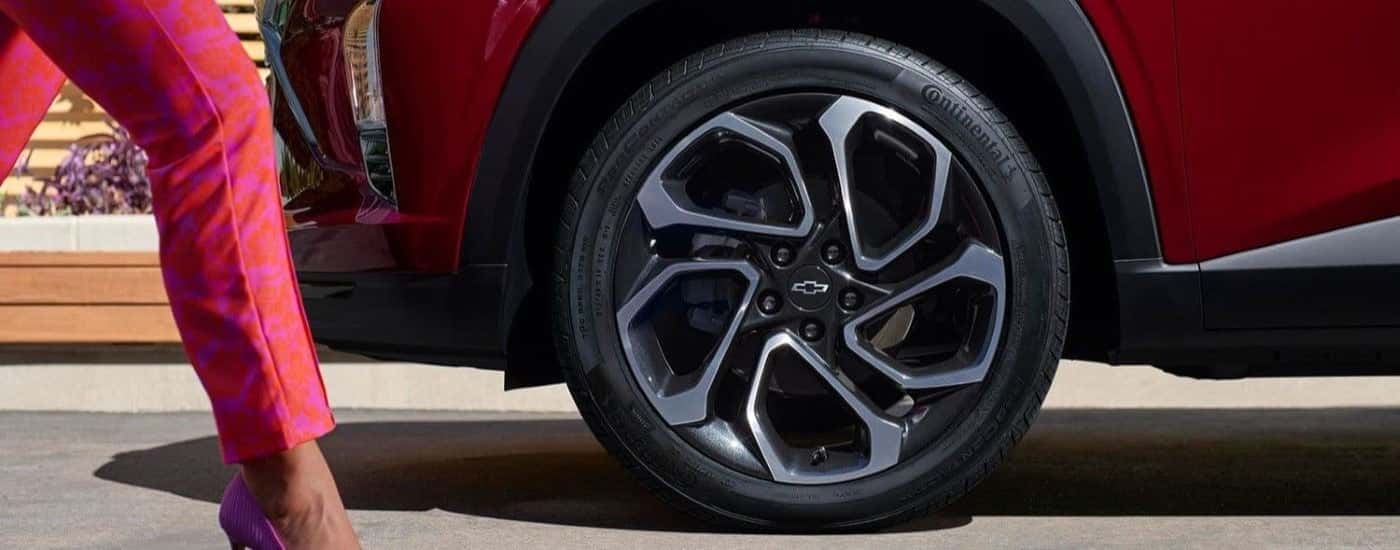 A close up show a chrome and black wheel on a red 2024 Chevy Trax RS