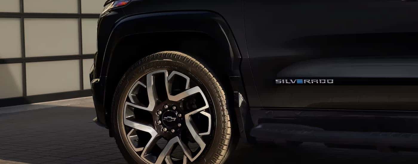 The rim of a black 2025 Chevy Silverado EV at a Houston electric Silverado dealer