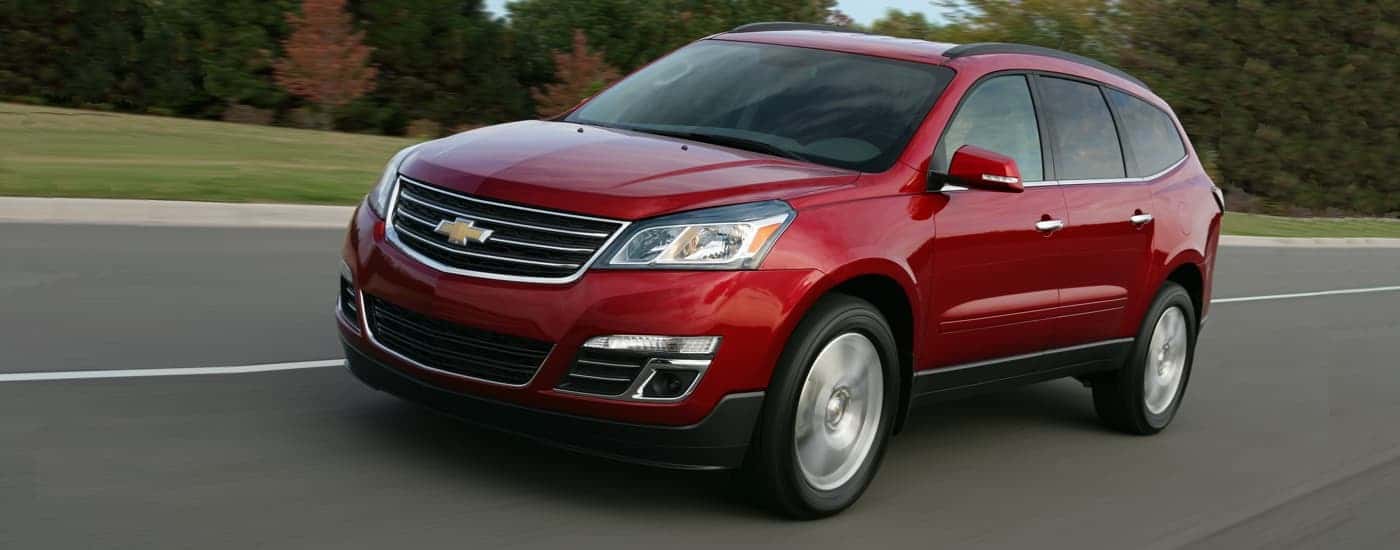 A red 2017 Chevy Traverse LTZ is shown driving on a highway
