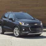 A black 2020 Chevy Trax is parked in front of a building.