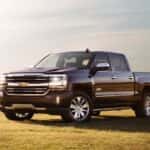 A burgundy 2017 Chevy Silverado is parked in a field.