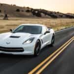 A white 2019 Chevy Corvette Stingray is shown from the front at an angle.