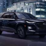 Black 2022 Chevy Traverse driving in a city