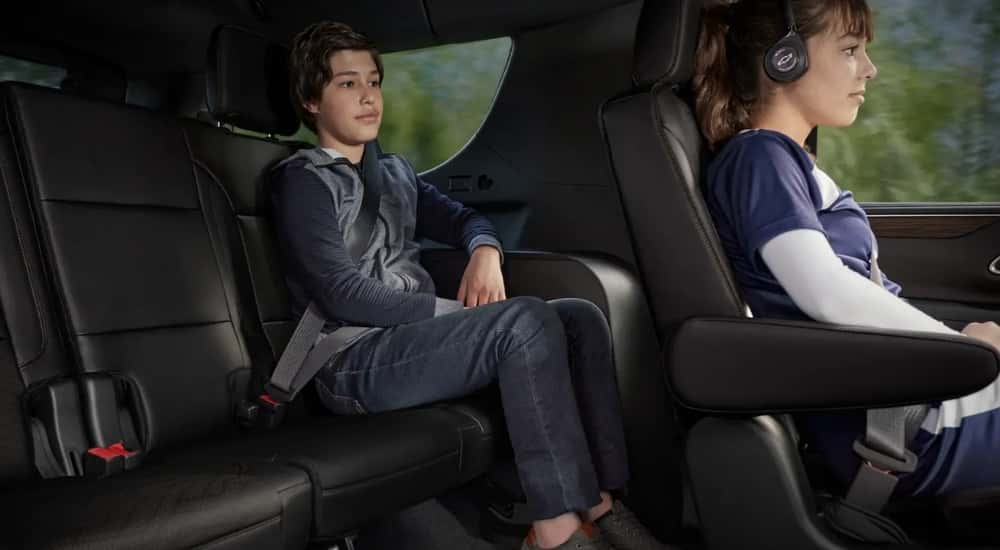 Children sitting in the black interior in a 2023 Chevy Tahoe