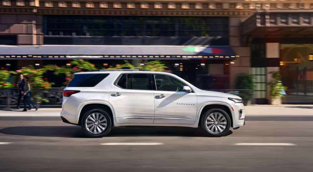 White 2023 Chevy Traverse driving to a used Chevy dealer near Houston