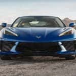 A blue 2022 Chevy Corvette Stingray is shown from the front parked in a remote location.