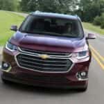 A purple 2018 Chevy Traverse is shown on an open road after looking at a used Chevy Traverse for sale near the Woodlands.