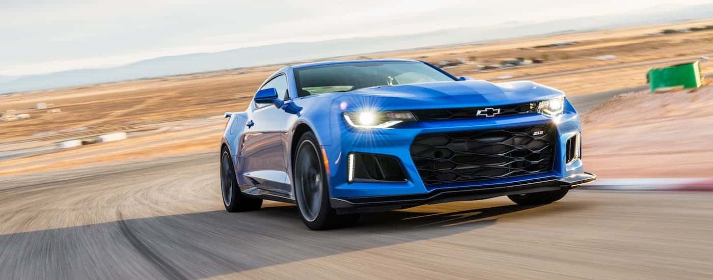One of the fastest used Chevrolets, a blue 2017 Chevy Camaro ZL1, is shown on a racetrack