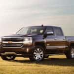 A black 2017 Chevy Silverado 1500 is shown from the side parked in a field after leaving a used Chevy truck in Houston.