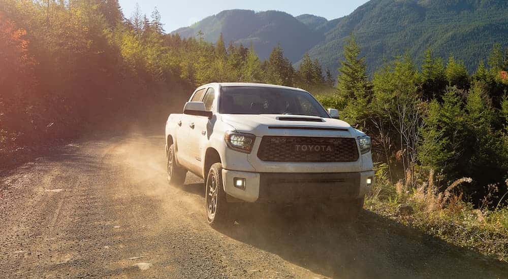 White 2021 Toyota Tundra TRD driving to see used cars for sale near Cypress