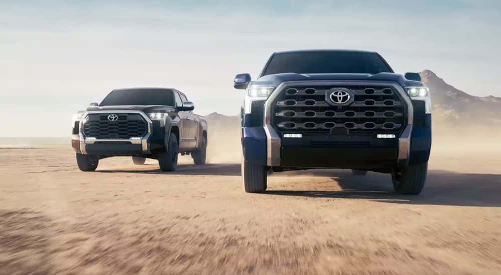 A 2023 Toyota Tundra Platinum Edition driving next to a 1794 Edition