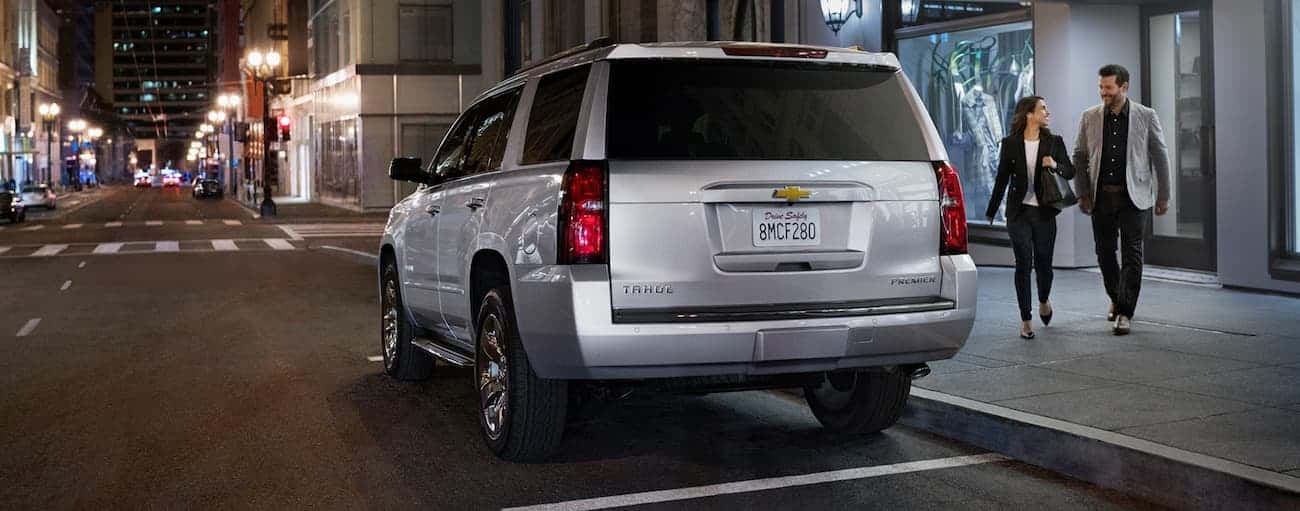 Rear of a silver 2020 Chevy Tahoe parked near a curb.