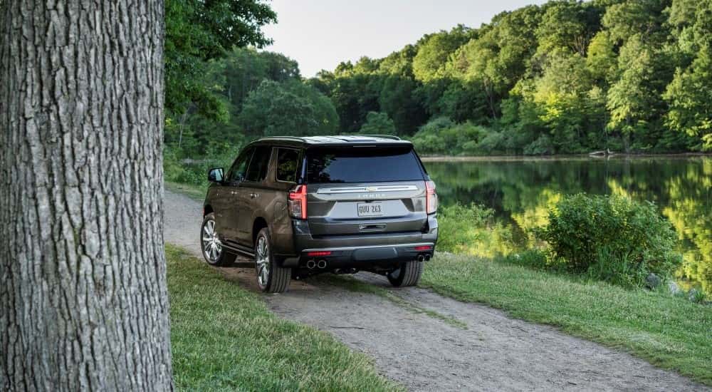 A gray 2021 Chevy Tahoe parked near a pond.