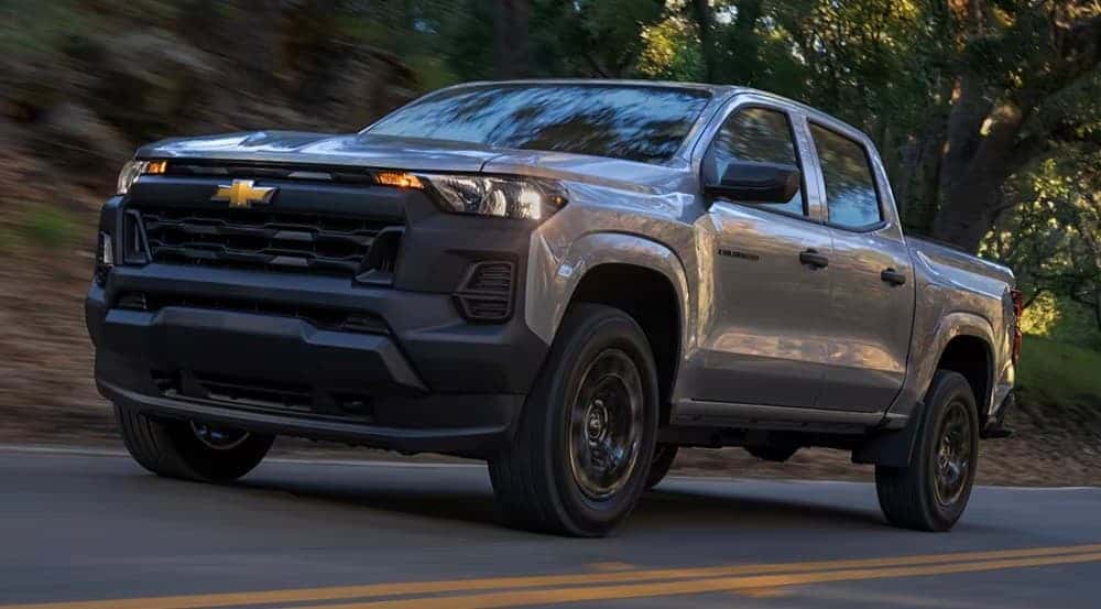 A silver 2026 Chevy Colorado for sale in Tomball driving on a highway.