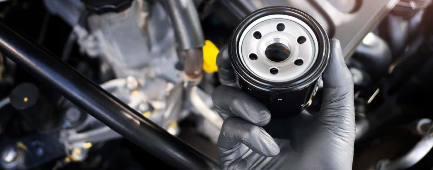 A technician holding an oil filter