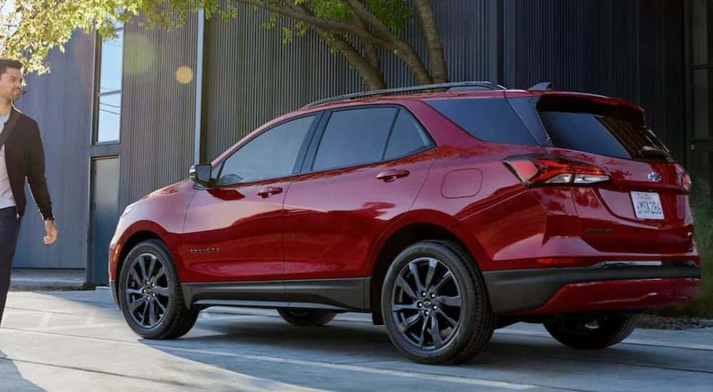 A red 2024 Chevy Equinox parked near used SUVs for sale near Houston.