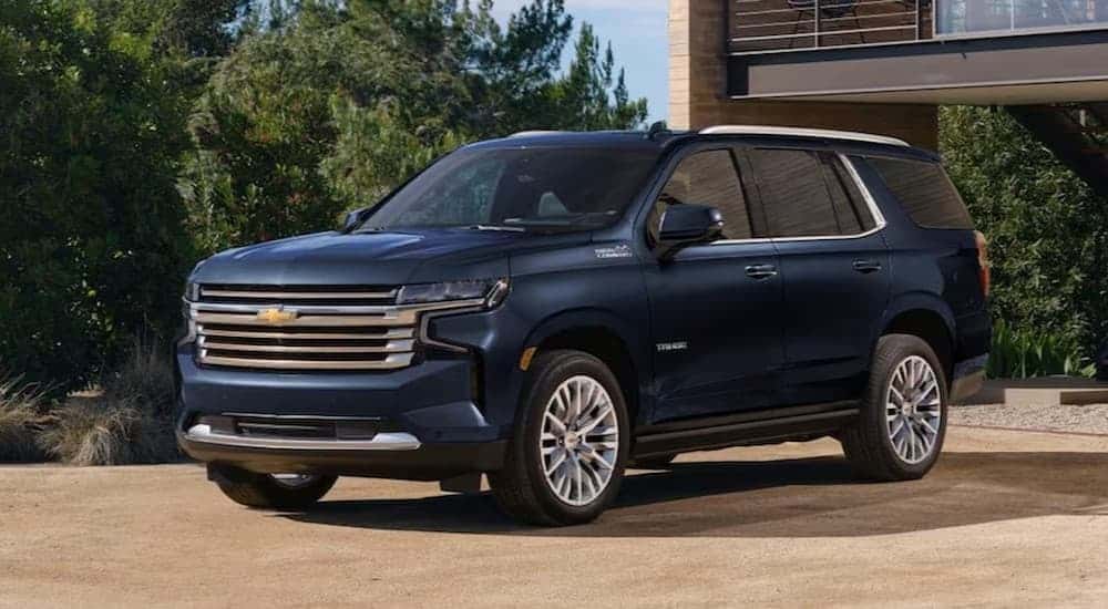 A blue 2024 Chevy Tahoe parked on a driveway.