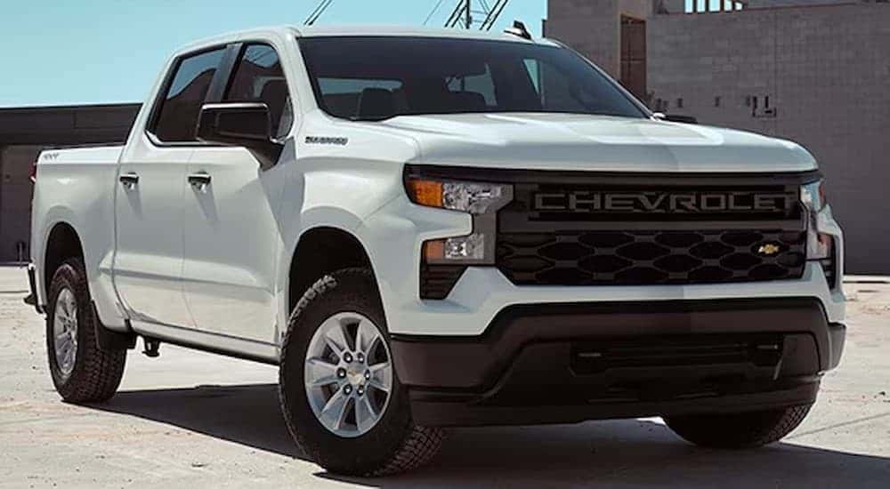 A white 2026 Chevrolet Silverado 1500 WT parked near a building.