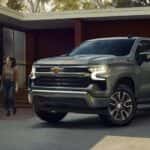 A silver 2026 Chevy Silverado 1500 Z71 parked near a house.