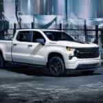 A white 2024 Chevy Silverado 1500 Rally Edition parked at a distillery.