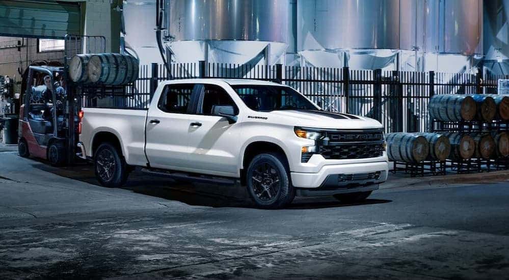 A white 2024 Chevy Silverado 1500 Rally Edition parked at a distillery.