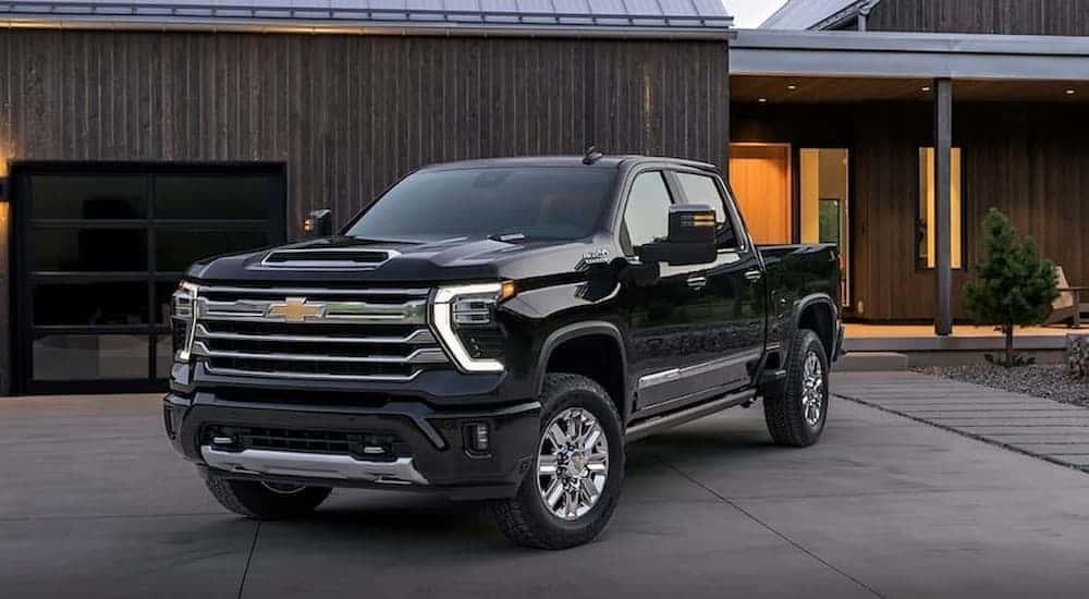 Ablack 2024 Chevy Silverado 2500 parked on a driveway.
