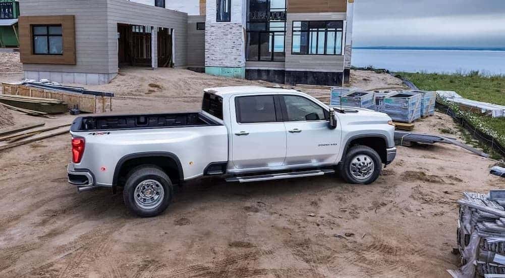 A white 2024 Chevy Silverado 3500 parked on a construction site.