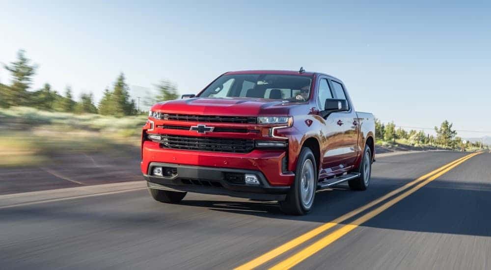 Red 2020 Chevy Silverado 1500 driving down a road