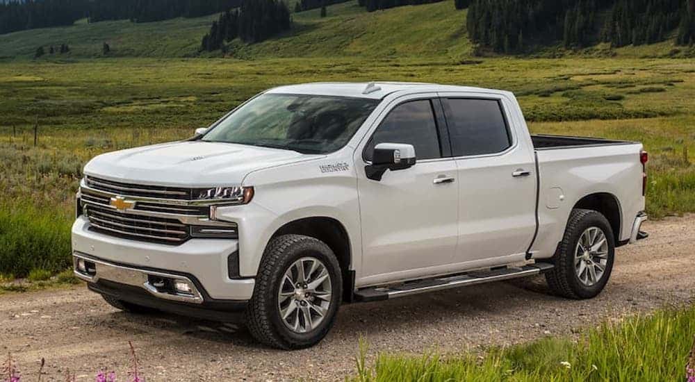 White 2021 Chevy Silverado 1500 driving down a dirt road