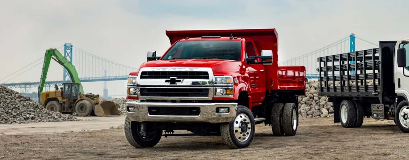 Red 2024 Chevy Silverado 4500 HD parked on a construction site