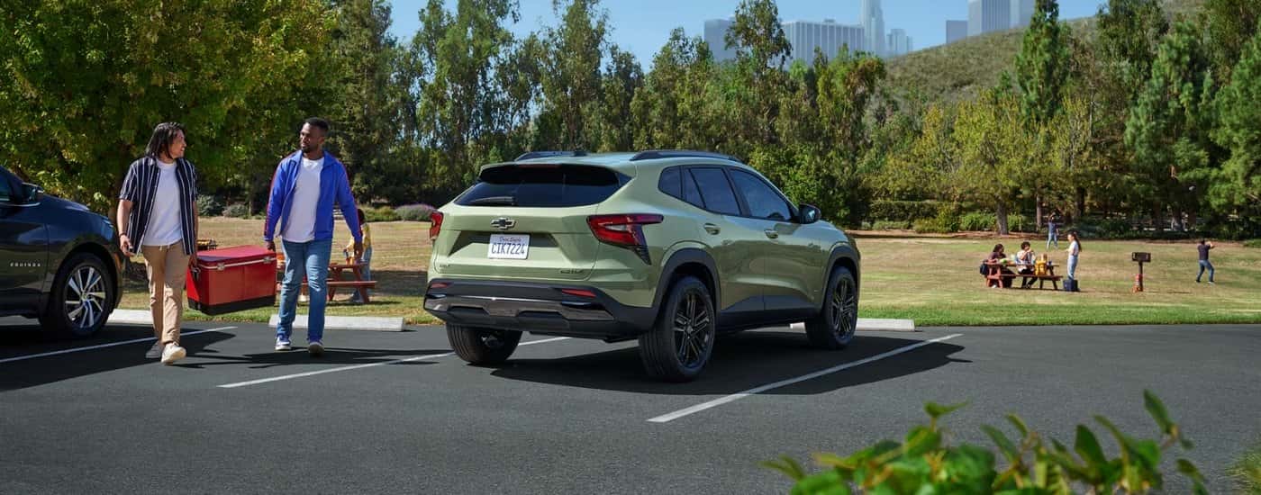 green 2025 chevy trax parked in front of trees