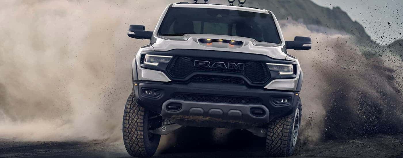 White 2021 Ram 1500 TRX sending up a dust cloud.