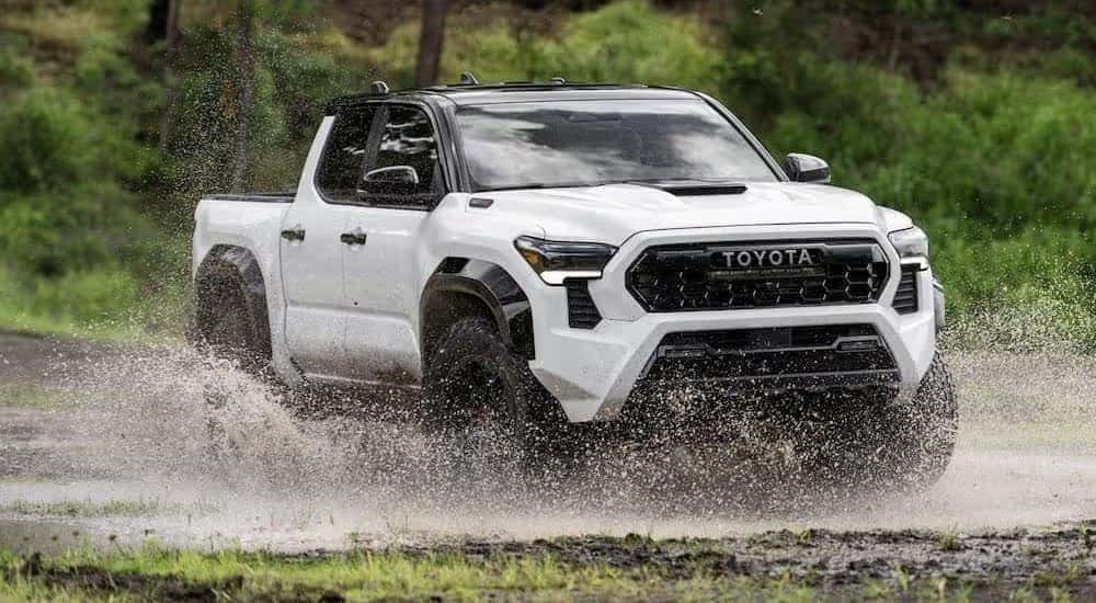 White 2024 Toyota Tacoma TRD Pro driving off-road