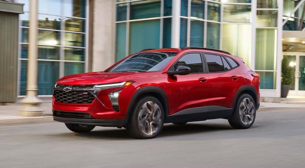 A red 2026 Chevy Trax 2RS parked in front of a building.