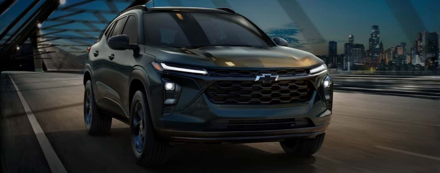 Black 2026 Chevy Trax Midnight Edition driving over a bridge